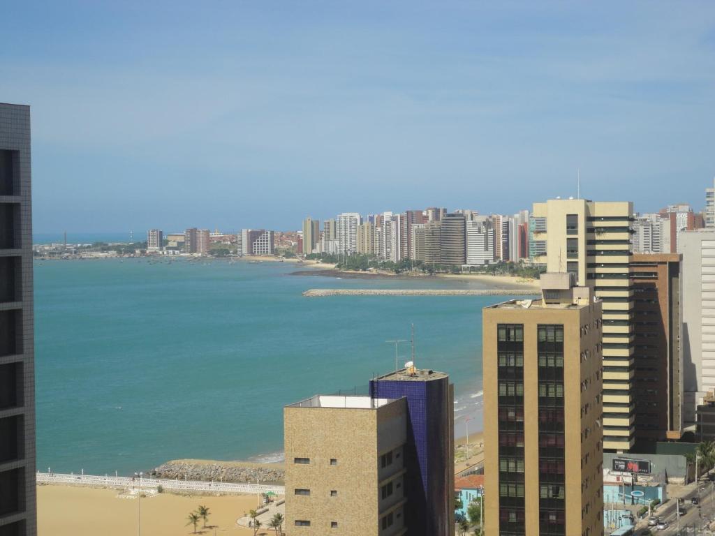 a view of a city with the ocean and buildings at VIP Beira Mar Residence in Fortaleza
