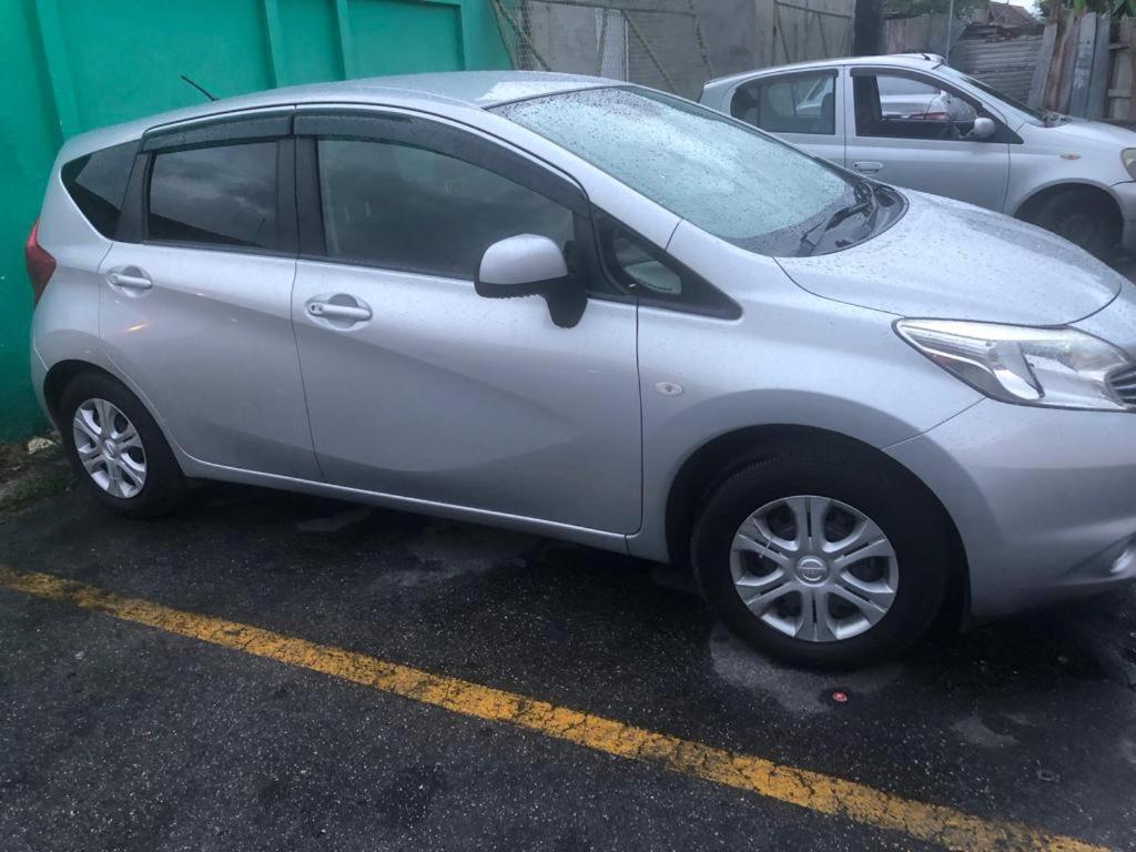 a small silver car parked in a parking lot at Breezy Apts in Saint Philip