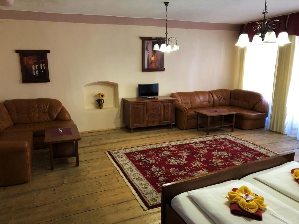 a living room with a couch and a table at Pension Pod Radnicí in Český Krumlov