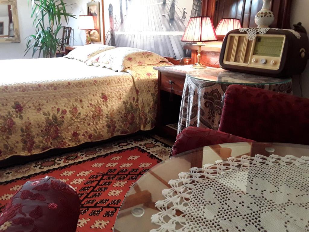 a room with two beds and a table with a tv at Studios Kono in Kotor