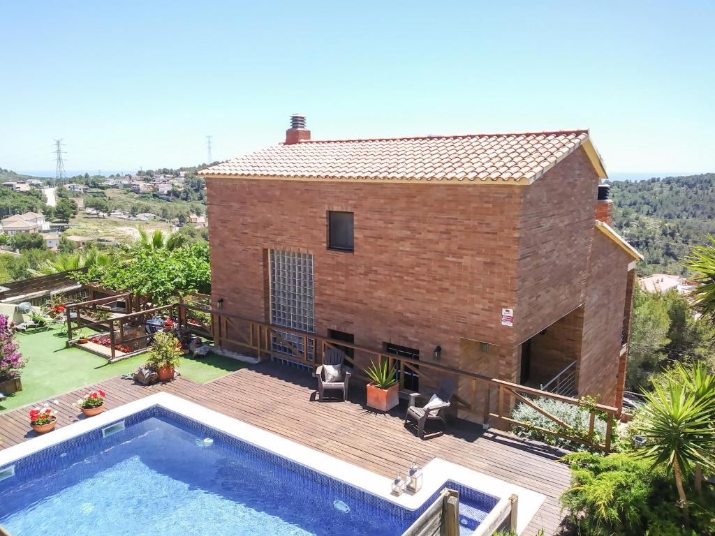 a villa with a swimming pool and a house at Villa Mar & Natura Sitges in Canyelles