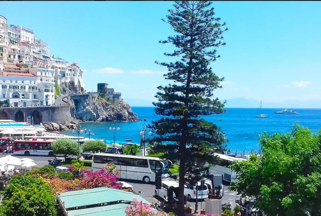 a view of the ocean and a pine tree at Il Pennello in Amalfi