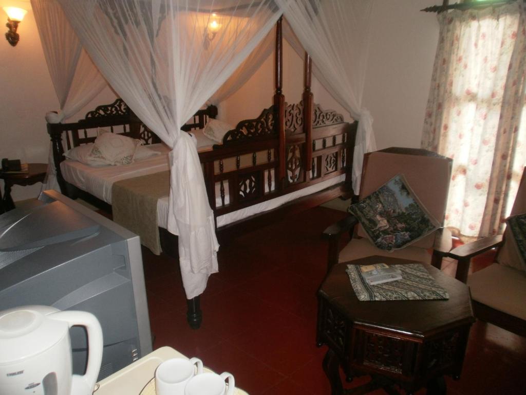 Postel nebo postele na pokoji v ubytování Asmini Palace Hotel