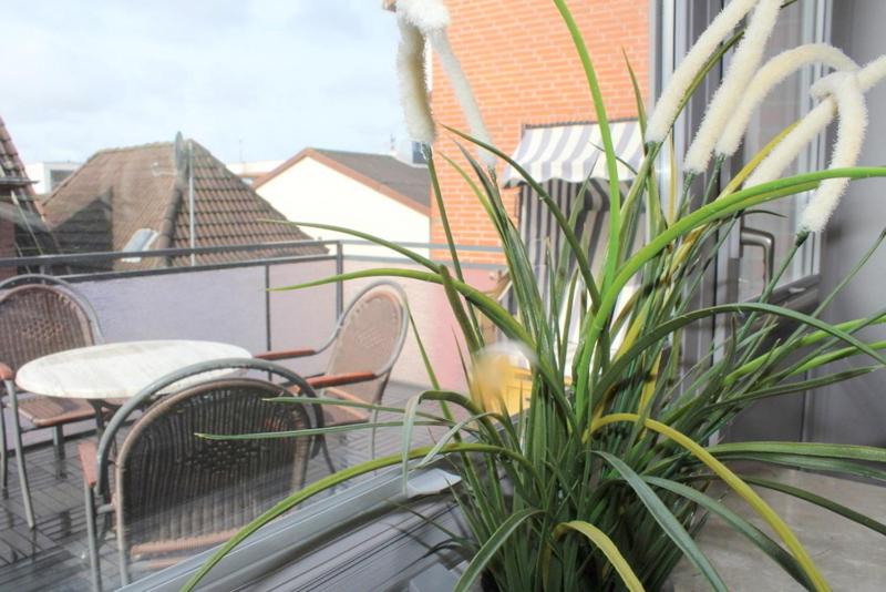 een plant op een balkon met een tafel en stoelen bij Appartment Vermietung Lütje in Büsum