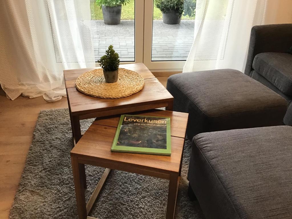 a living room with a coffee table with a book on it at Apartment 1 in Leverkusen