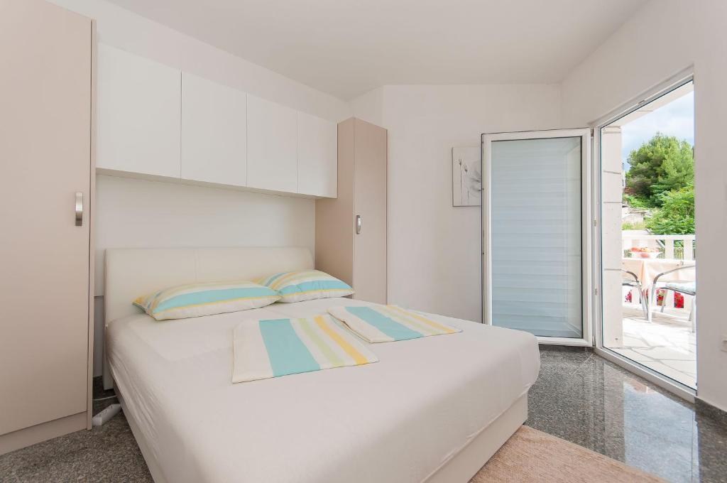 Postel nebo postele na pokoji v ubytování Apartmani Vesna