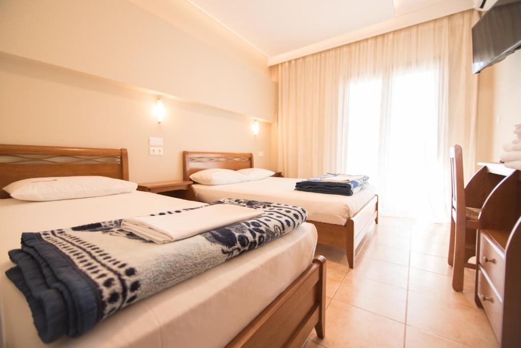 Łóżko lub łóżka w pokoju w obiekcie acquablue apartments