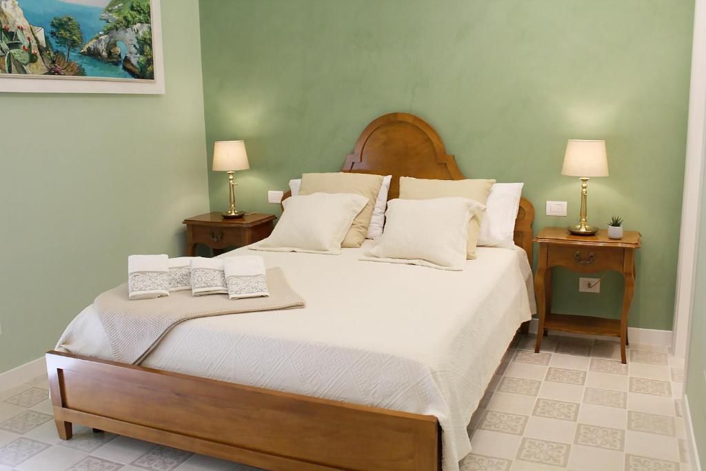 a bedroom with a large bed with two night stands at Estlevante B&B in Vieste