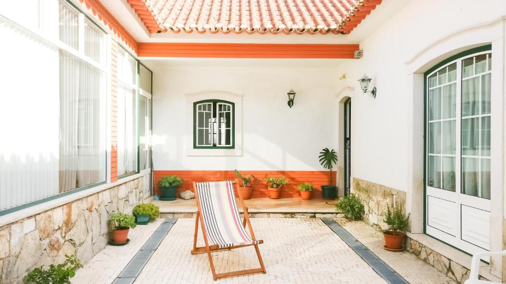 a chair on the porch of a house at Rustic Holiday House in the Natural Park in Alcobertas