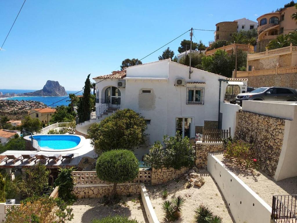 a villa with a swimming pool and a house at villa Grace,10p,seaview,pool in Calpe