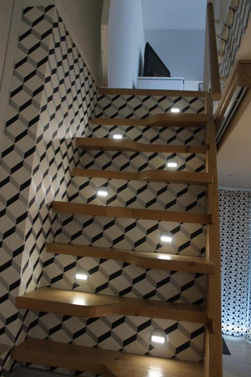 a staircase with black and white tiles on the wall at Claude et Marie-France in Alata