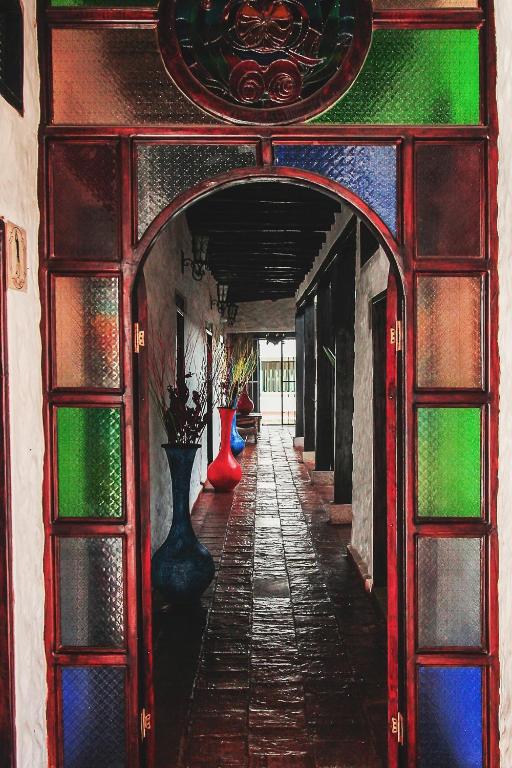 an archway with colorful glass and vases on a building at Casona Quesada in Suesca