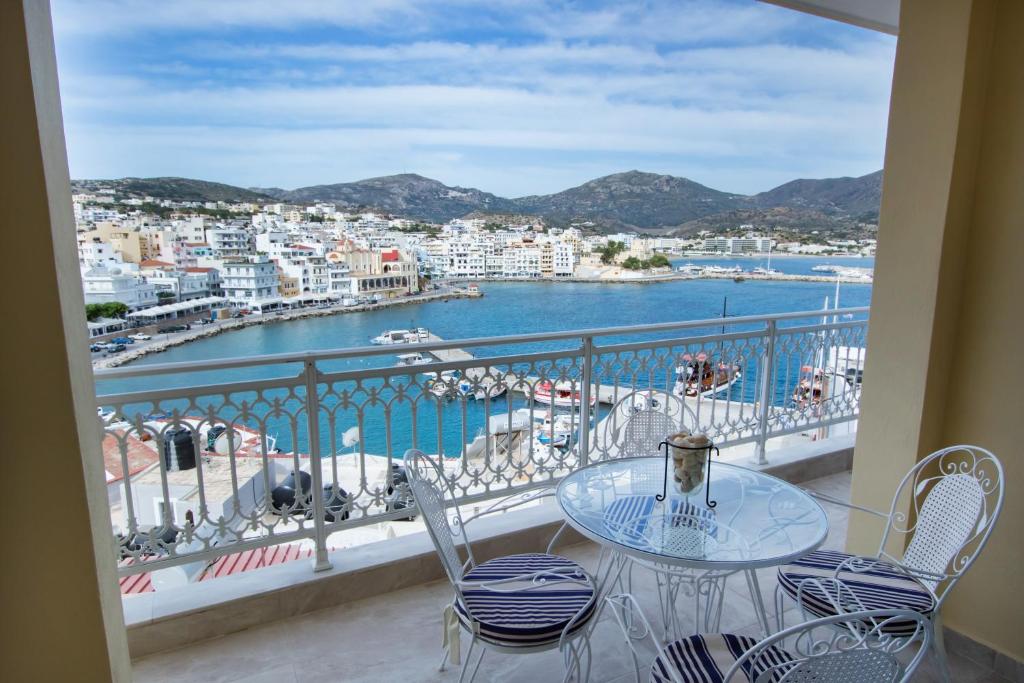 a balcony with a table and chairs and a view of a harbor at Casa Jokaste in Karpathos