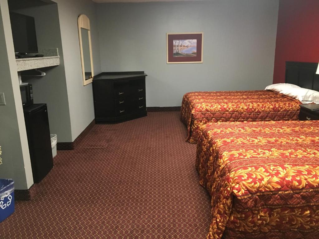 Postel nebo postele na pokoji v ubytování Haven Inn & Suites