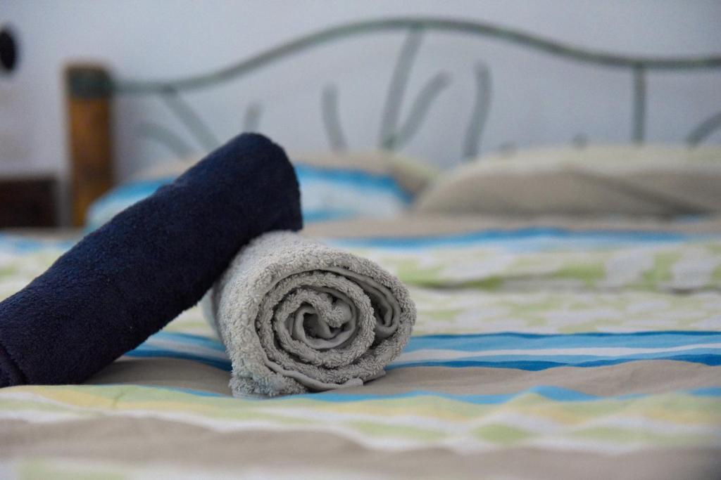 a rolled up towel on top of a bed at Sweet Home, Only 7 Min to the beach - By SEAELO EILAT in Eilat