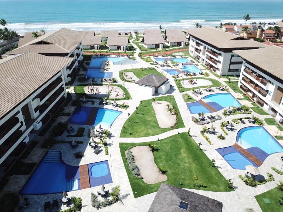 an aerial view of a resort with the beach at Cupe Beach Living Beira Mar Flats Azure e Royal in Porto De Galinhas