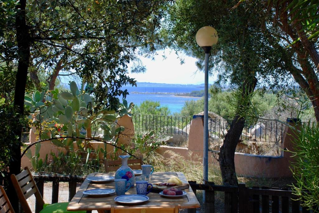 a wooden table with a view of the water at Villa Bianca in Capitana