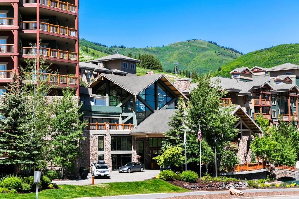 a large apartment building with cars parked in front of it at Condos at Canyons Resort by White Pines in Park City