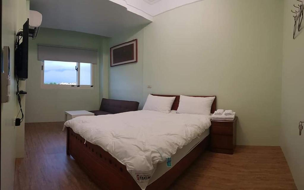 Postel nebo postele na pokoji v ubytování JiuZhiAn Apartment