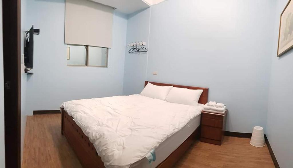 Postel nebo postele na pokoji v ubytování JiuZhiAn Apartment