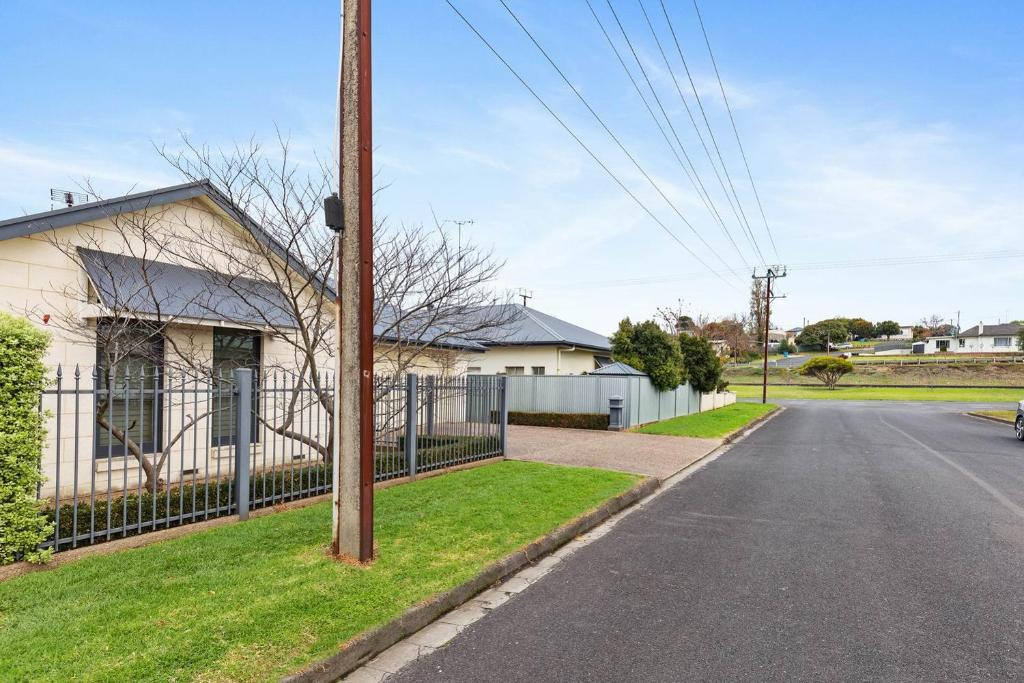 an empty street in front of a house at Domain One Apartment in Mount Gambier