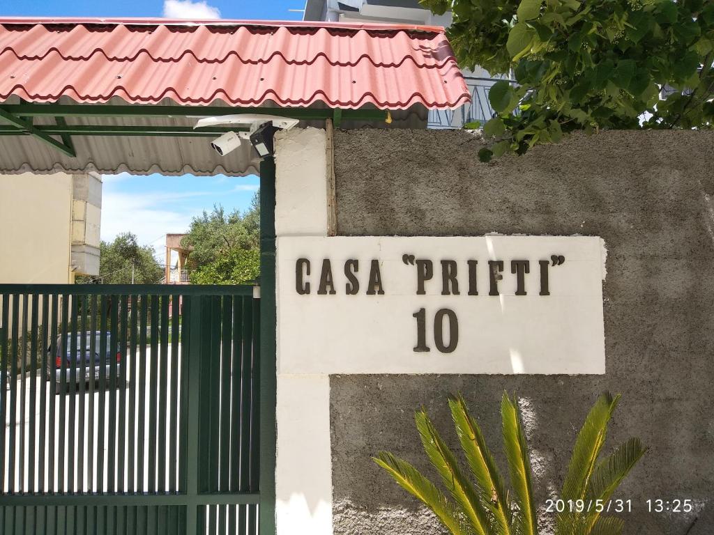 a sign that reads casa prefix next to a gate at Casa Prifti in Vlorë