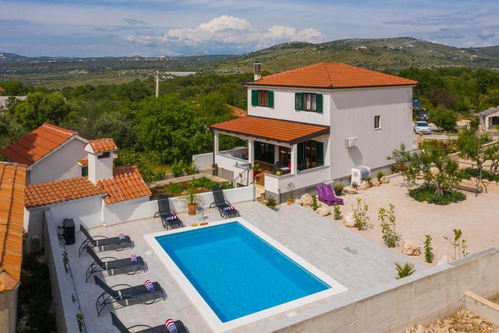 an aerial view of a house with a swimming pool at Villa Sunshine in Rogoznica