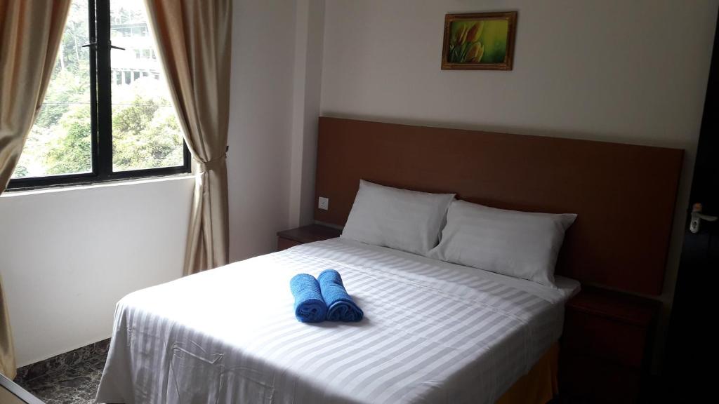 Postel nebo postele na pokoji v ubytování TULIP HOTEL & APARTMENT