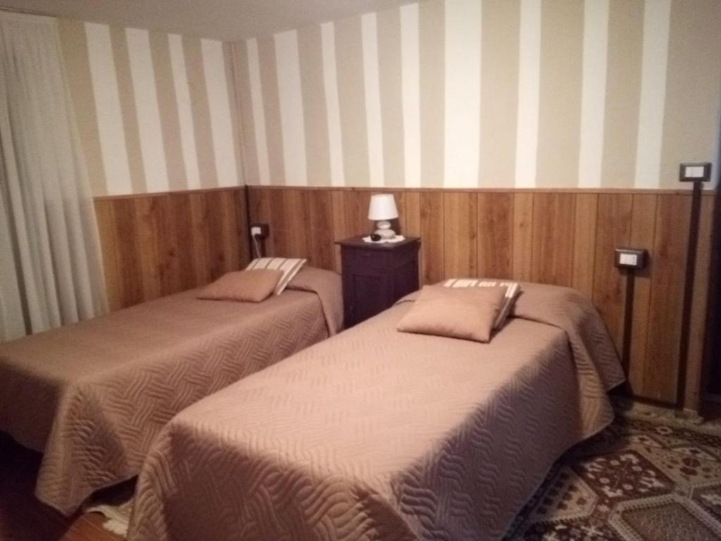 a room with two beds in a room at Casa Vacanza PIZZO CAMINO in Calasca Castiglione