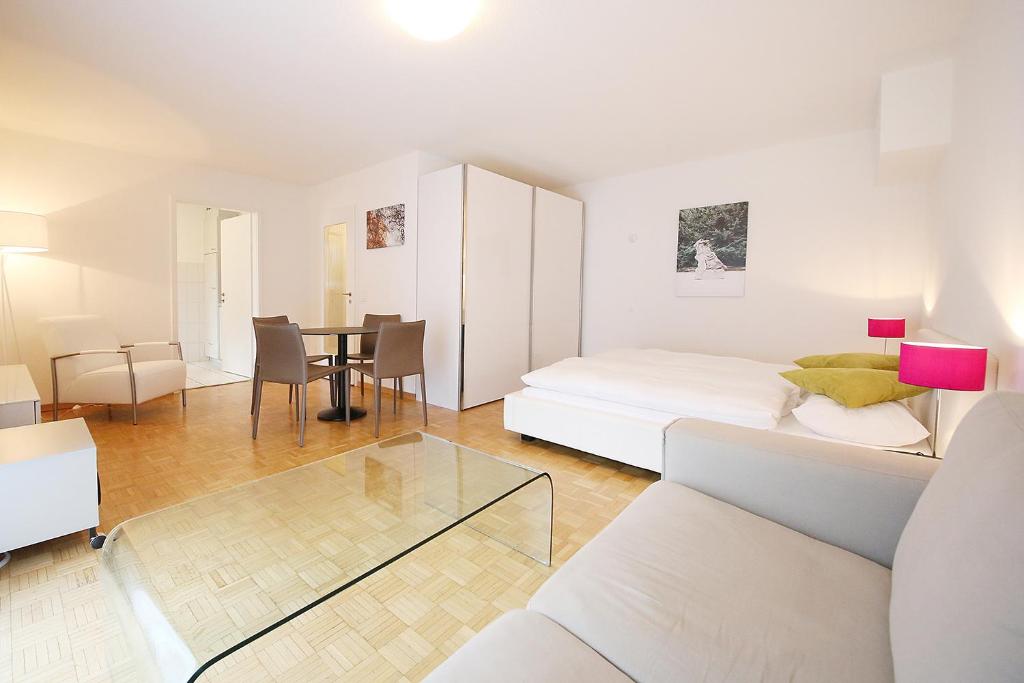 a living room with a bed and a table at CITY STAY - Kirchweg in Zürich