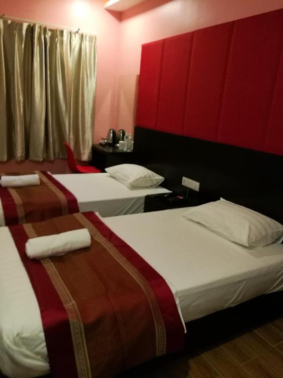 Postel nebo postele na pokoji v ubytování D'Spark Hotel Bayu