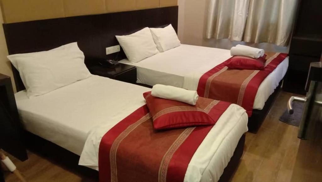 Postel nebo postele na pokoji v ubytování D'Spark Hotel Bayu