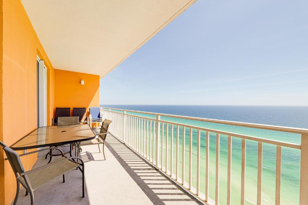 a balcony with a table and chairs and the ocean at Splash Resort 1903W in Panama City Beach