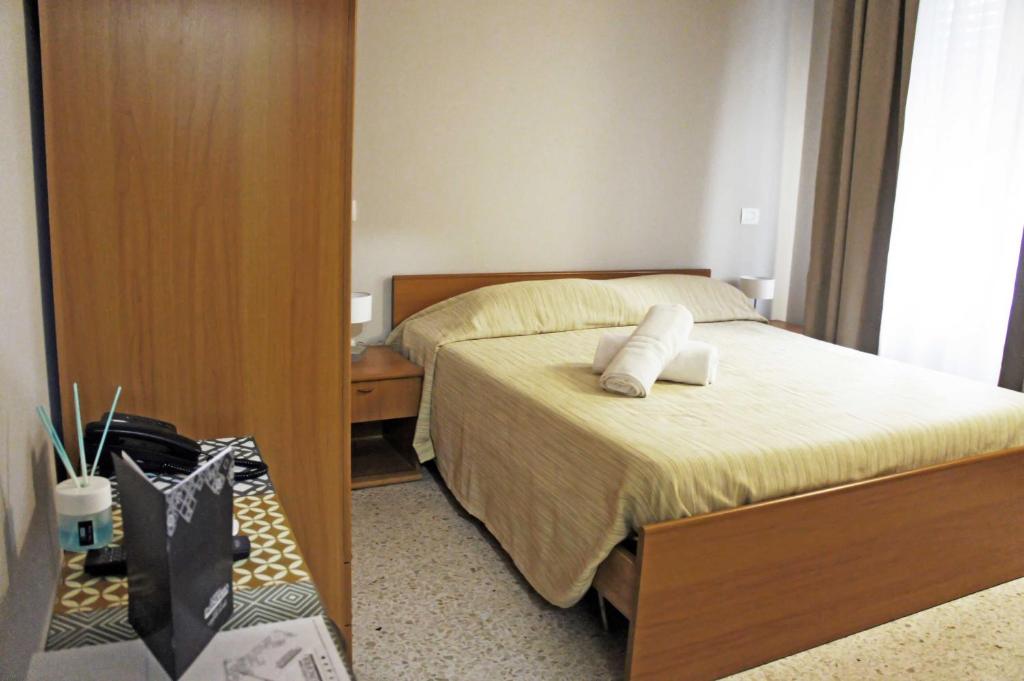 Postel nebo postele na pokoji v ubytování Albergo D'Onofrio