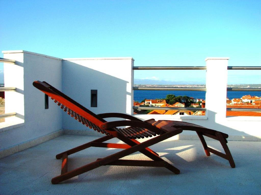 uma cadeira numa varanda com vista para o oceano em Le Refuge em Preko