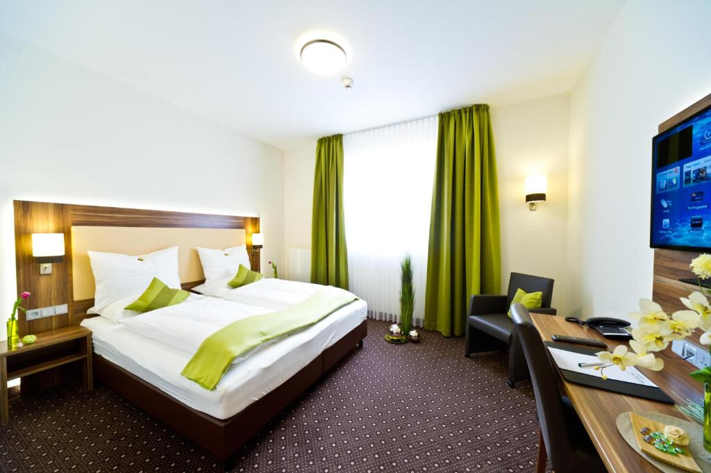 Postel nebo postele na pokoji v ubytování Wohlfühl-Hotel Neu Heidelberg