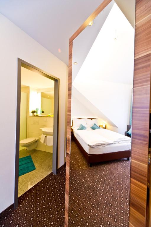 Postel nebo postele na pokoji v ubytování Wohlfühl-Hotel Neu Heidelberg