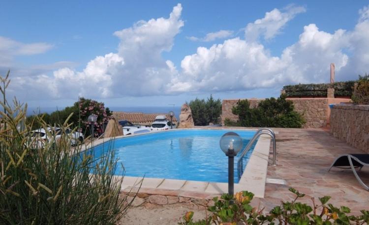 a swimming pool with a view of the ocean at Villino Saccu in Costa Paradiso