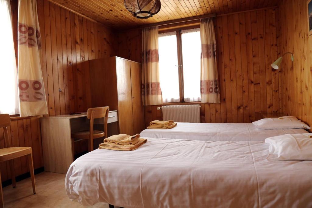 Postel nebo postele na pokoji v ubytování Hôtel de Torgon