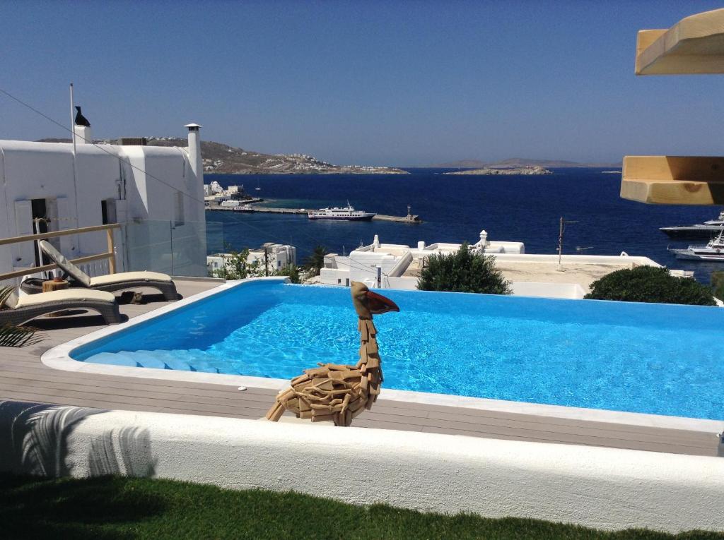 a statue of a giraffe next to a swimming pool at Seatinview Lodges in Mikonos