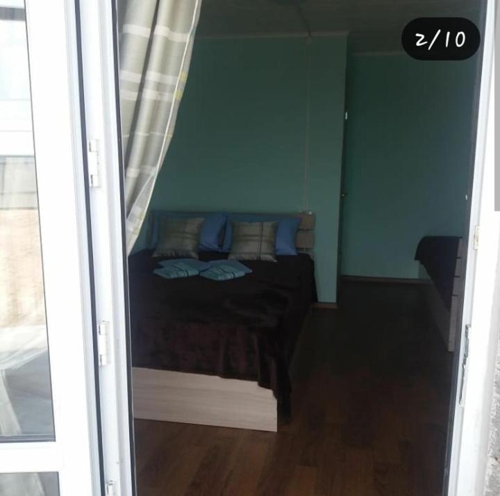 a bedroom with a bed with blue walls at Отдых на Балхаше in Balqash
