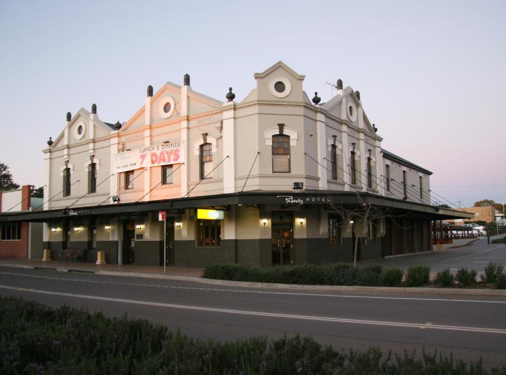 a large building on the corner of a street at Peden's Hotel in Cessnock
