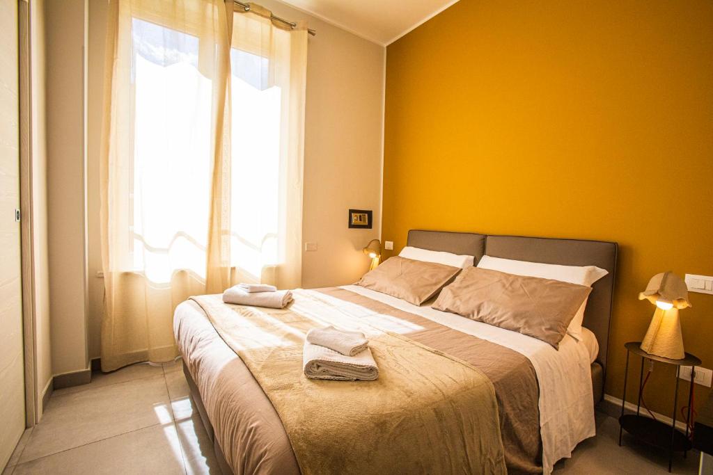 a bedroom with a large bed with yellow walls at Garibaldi 136 in Naples