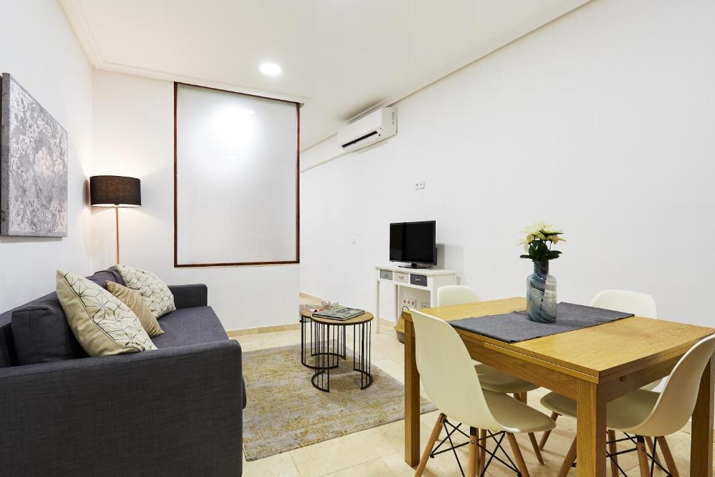 ein Wohnzimmer mit einem Sofa und einem Tisch in der Unterkunft LEEWAYS LOFT V in GRAN VÍA in Madrid