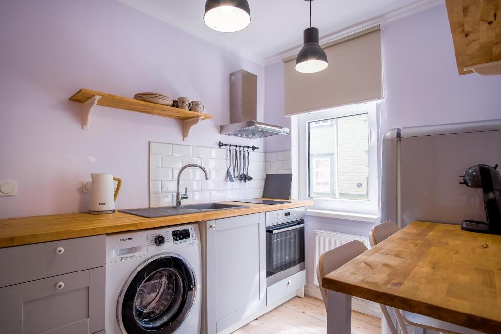 a kitchen with a washing machine and a sink at Dream Stay - Authentic Studio near Seaplane Harbour in Tallinn