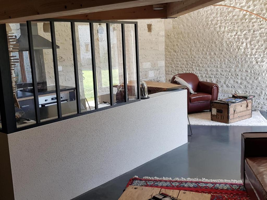 a living room with a table and a couch at Les Hauts De Chalonne in Le Gond-Pontouvre