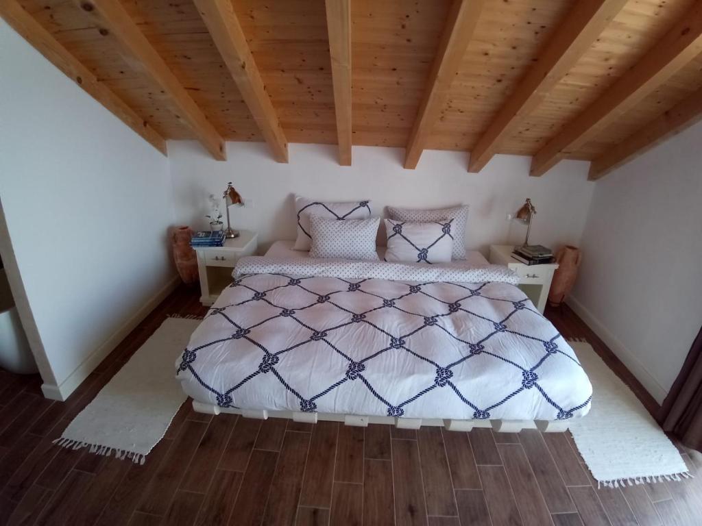 a bedroom with a bed and a wooden ceiling at Captain's Attic in Račišće