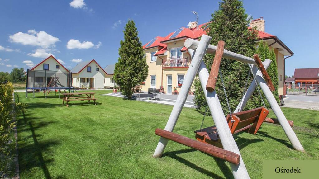 a park with a swing set in the grass at Wilaneska by Aparts Care in Sianozety