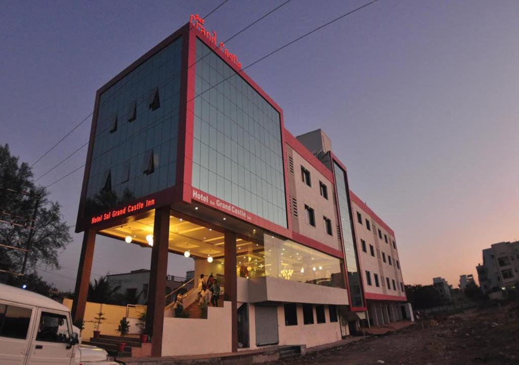 a building with a red trim on the side of it at Hotel Sai Grand Castle Inn in Shirdi