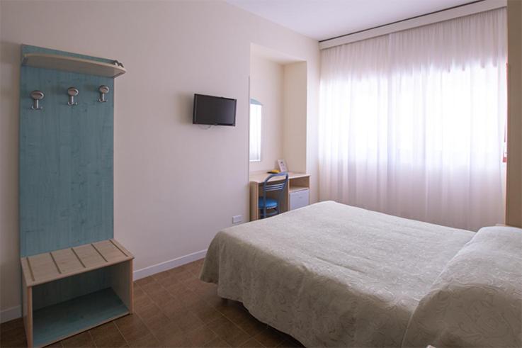 Postel nebo postele na pokoji v ubytování Hotel Scacciapensieri